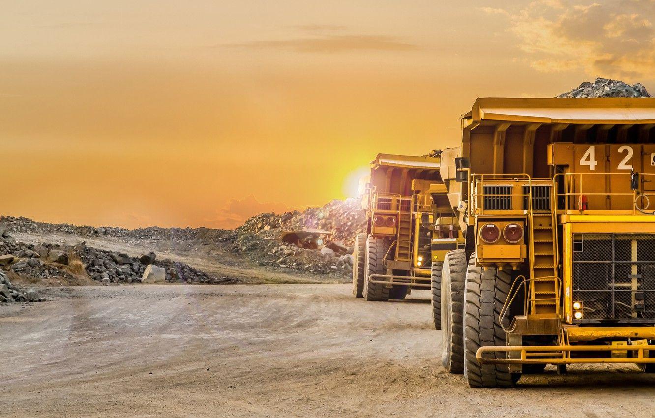 Heavy mining haul trucks at a frontier market open-pit mine